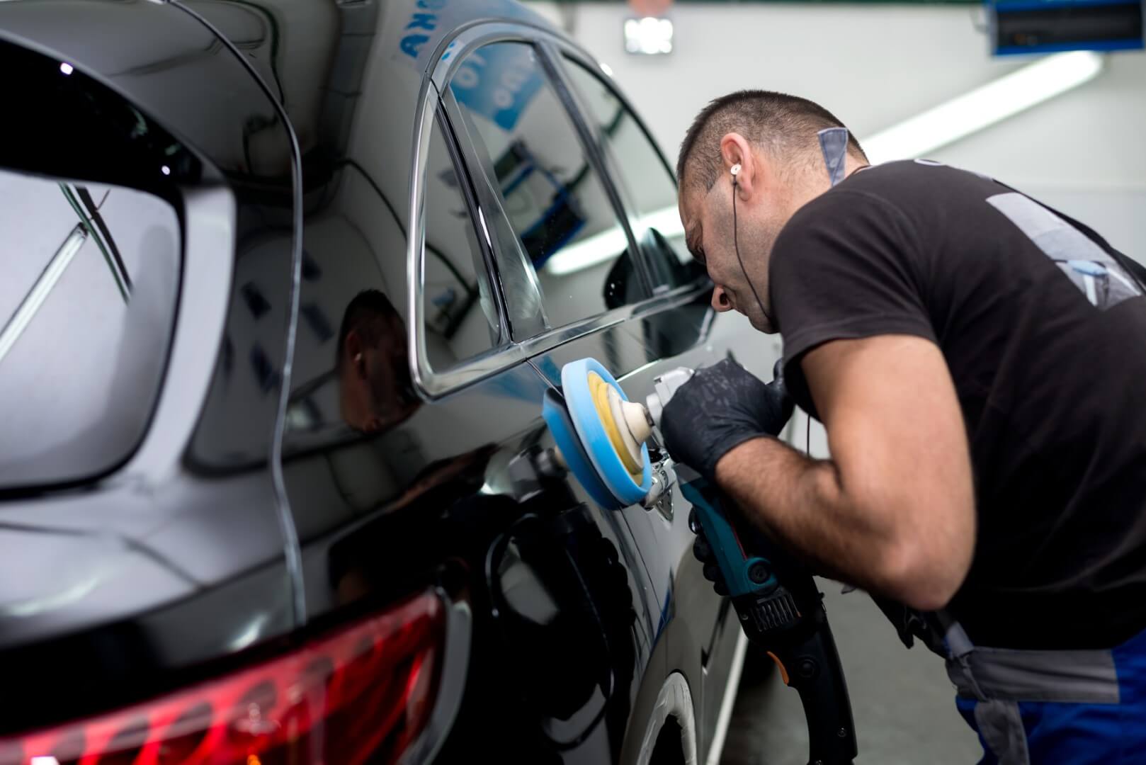 Car detailing expert from Scarborough waxing a car.